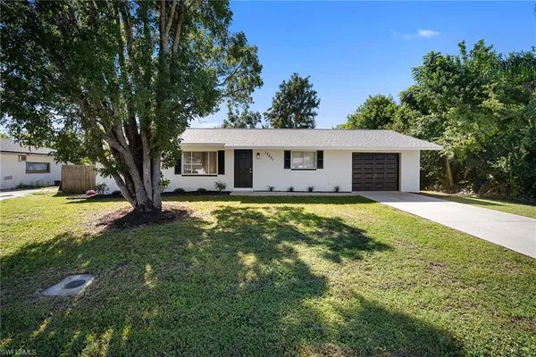 a front view of house with yard swimming pool and green space