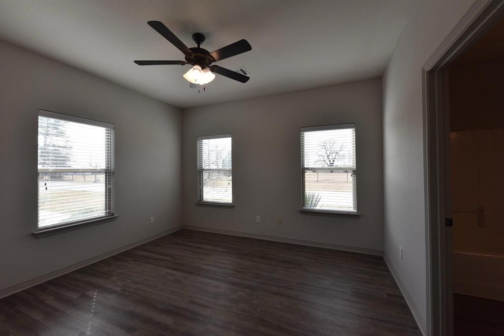 101 Capps Street, Unit A Rio Vista, TX 76093 - Photo 8 of 17 a view of an empty room with wooden floor and a window