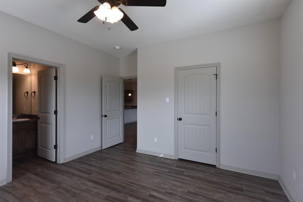 101 Capps Street, Unit A Rio Vista, TX 76093 - Photo 6 of 17 wooden floor in an empty room with a window