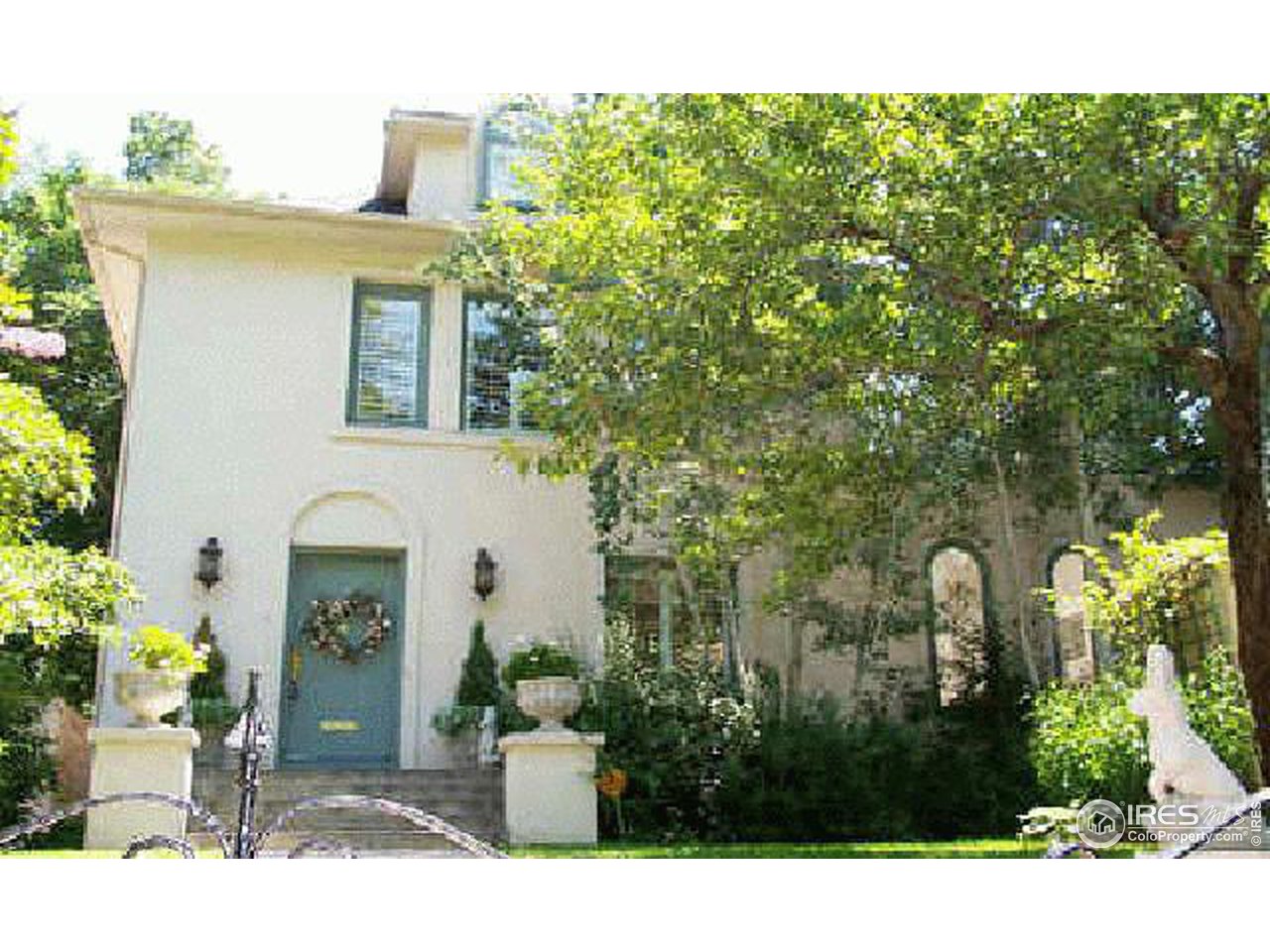a couple of potted plants in front of a house