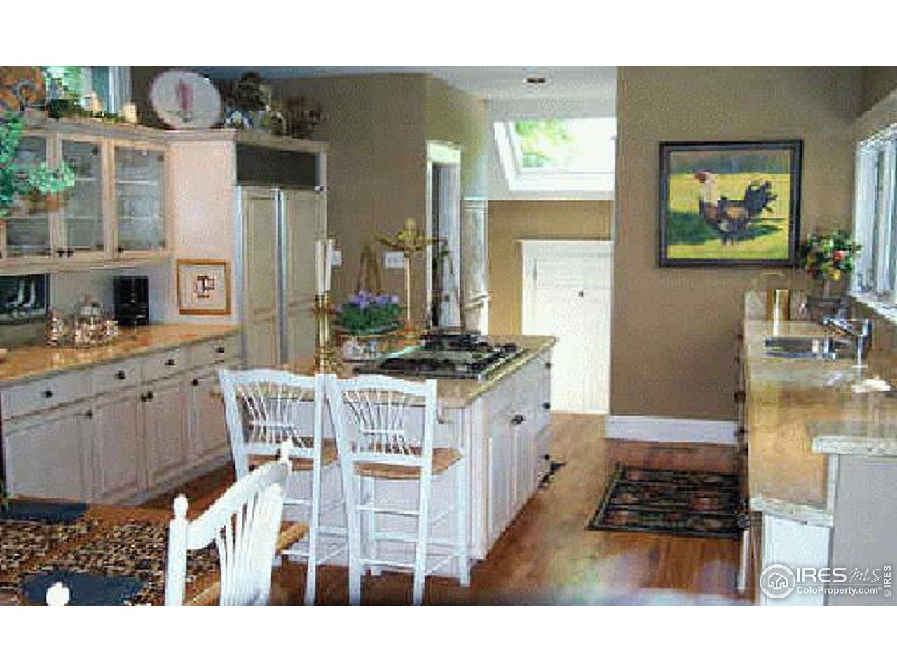 610 Vine Street Denver, CO 80206 - Photo 5 of 5 a kitchen with stainless steel appliances kitchen island granite countertop a stove and cabinets