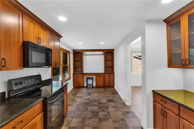 a kitchen with stainless steel appliances a stove microwave and sink