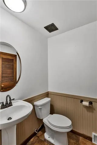 a bathroom with a sink mirror vanity and toilet