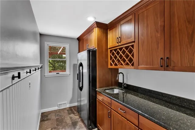 a kitchen with stainless steel appliances granite countertop a refrigerator and a stove