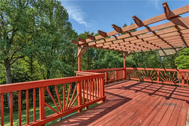 a balcony with wooden floor and outdoor space