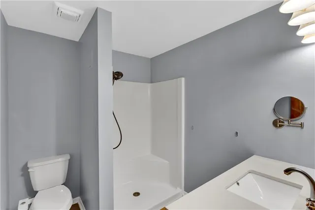a bathroom with a toilet and shower
