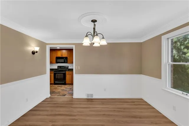 a view of a kitchen with microwave and cabinets