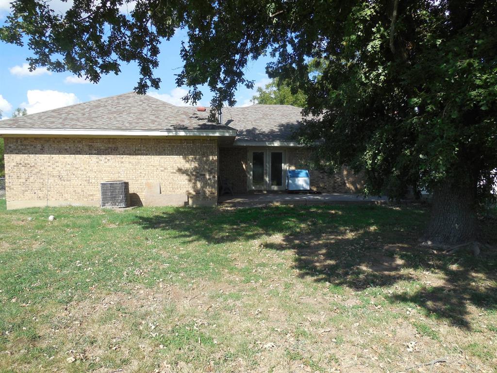 1220 Meadowbrook Street Ranger, TX 76470 - Photo 20 of 28 a front view of a house with garden