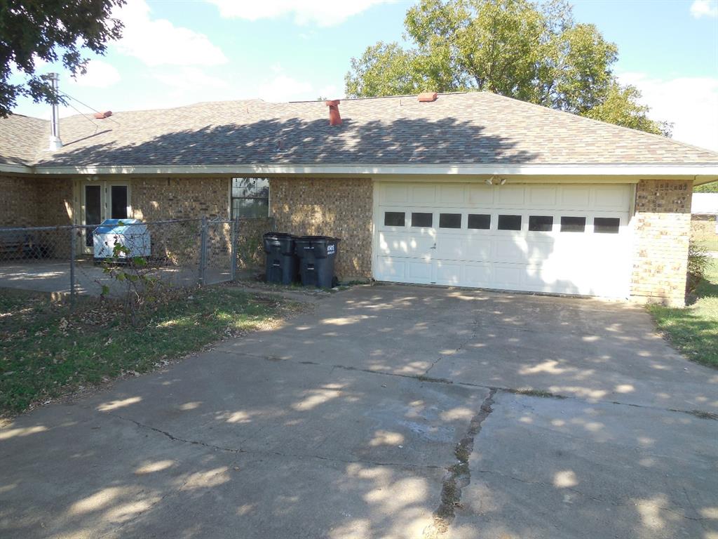 1220 Meadowbrook Street Ranger, TX 76470 - Photo 23 of 28 a view of a house with a yard and sitting area