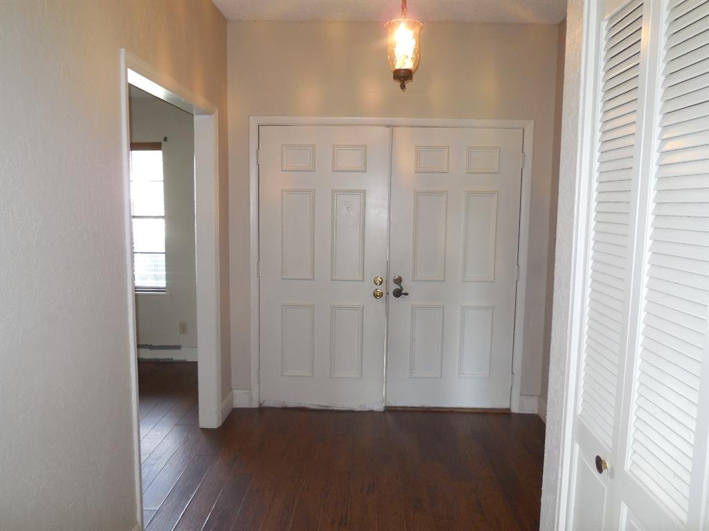 1220 Meadowbrook Street Ranger, TX 76470 - Photo 25 of 28 a view of a hallway with wooden floor