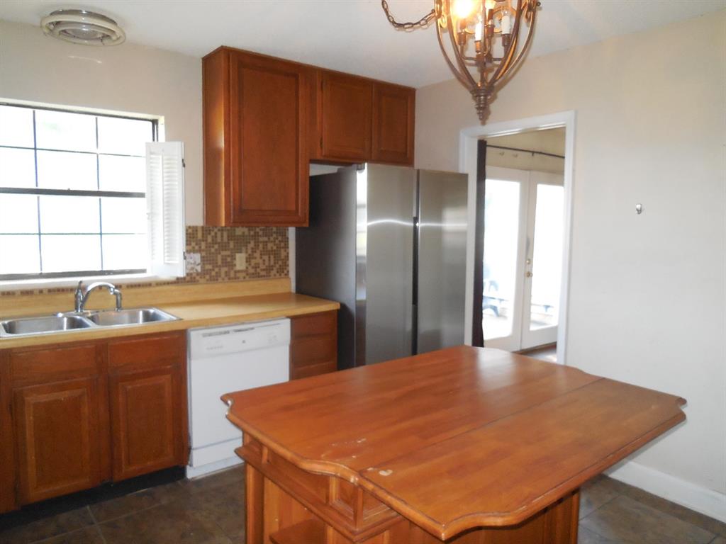 1220 Meadowbrook Street Ranger, TX 76470 - Photo 8 of 28 a kitchen with stainless steel appliances granite countertop a sink a refrigerator and a granite counter tops