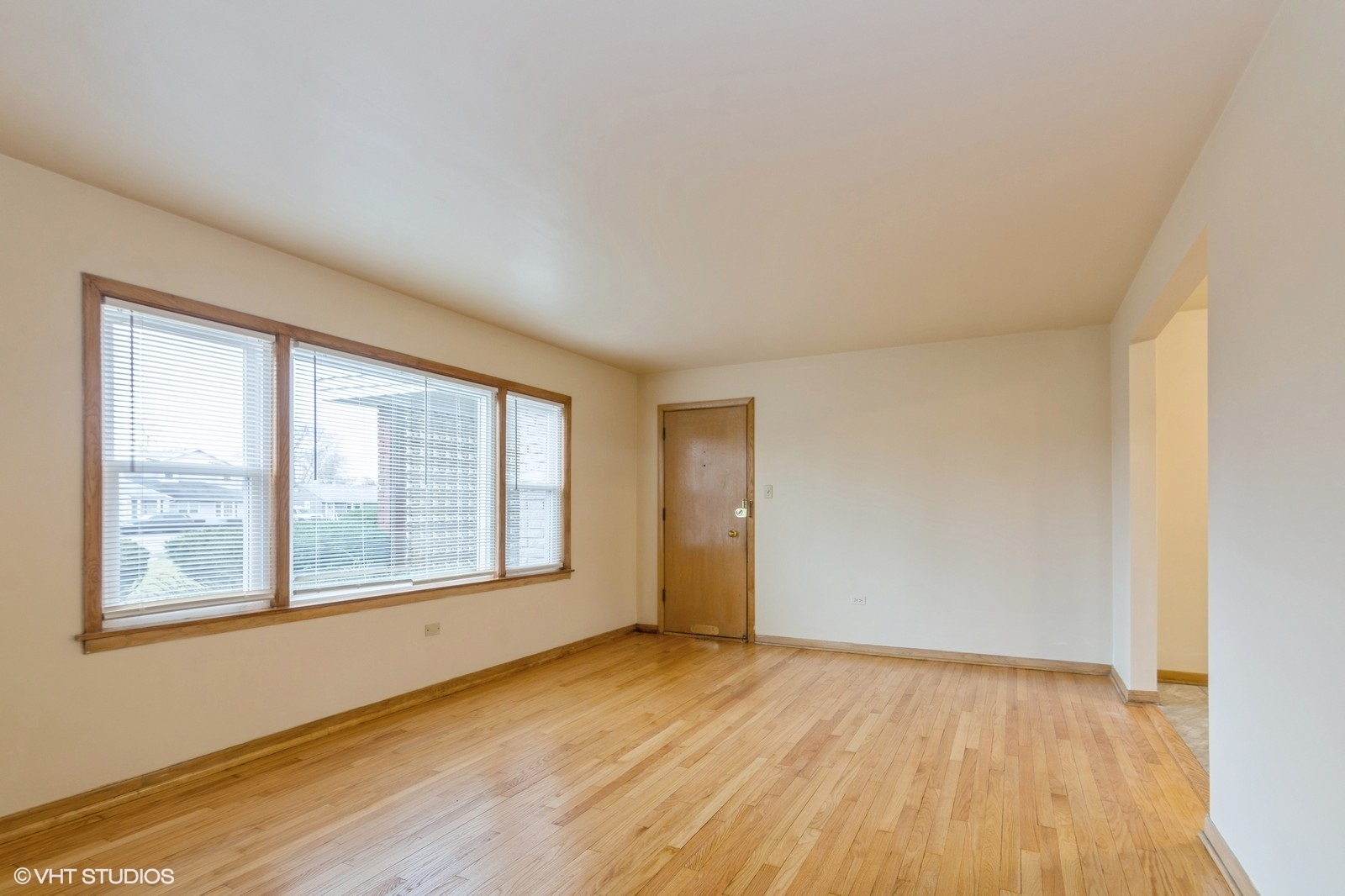 4434 West 87th Street, Unit 1E Chicago, IL 60652 - Photo 2 of 8 a view of an empty room with wooden floor and a window