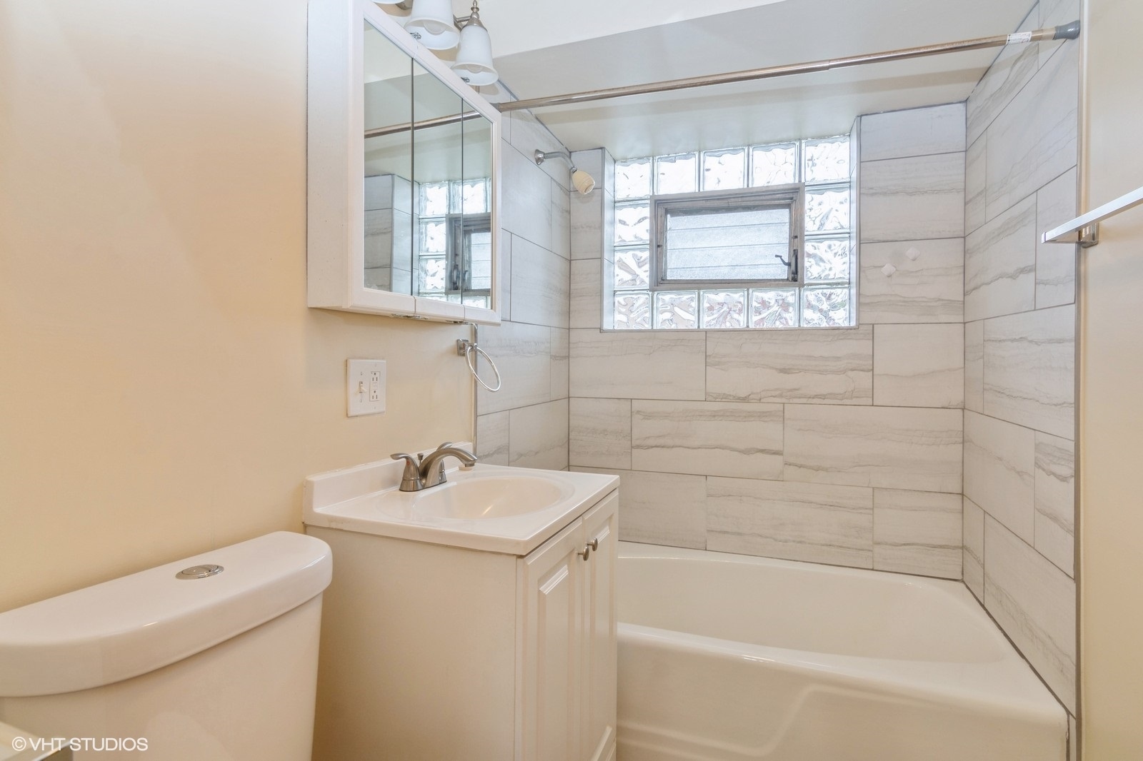 4434 West 87th Street, Unit 1E Chicago, IL 60652 - Photo 5 of 8 a bathroom with a sink a toilet and shower
