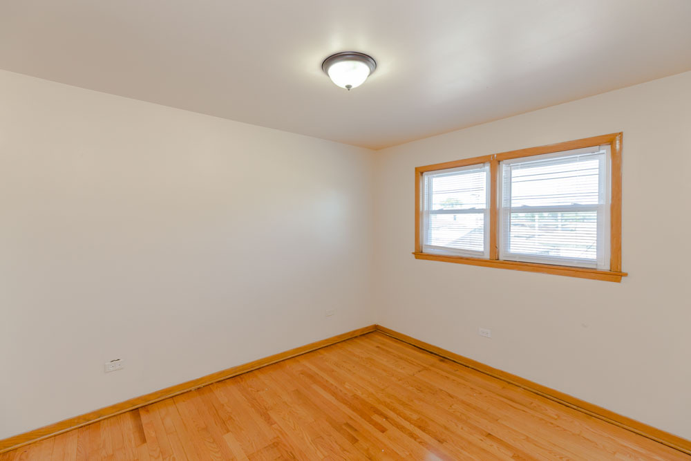 4434 West 87th Street, Unit 1E Chicago, IL 60652 - Photo 6 of 8 a view of a room with wooden floor and windows