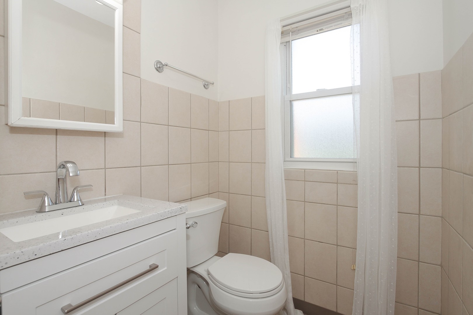 439 Elmhurst Road Mount Prospect, IL 60056 - Photo 11 of 24 a bathroom with a sink a toilet and window