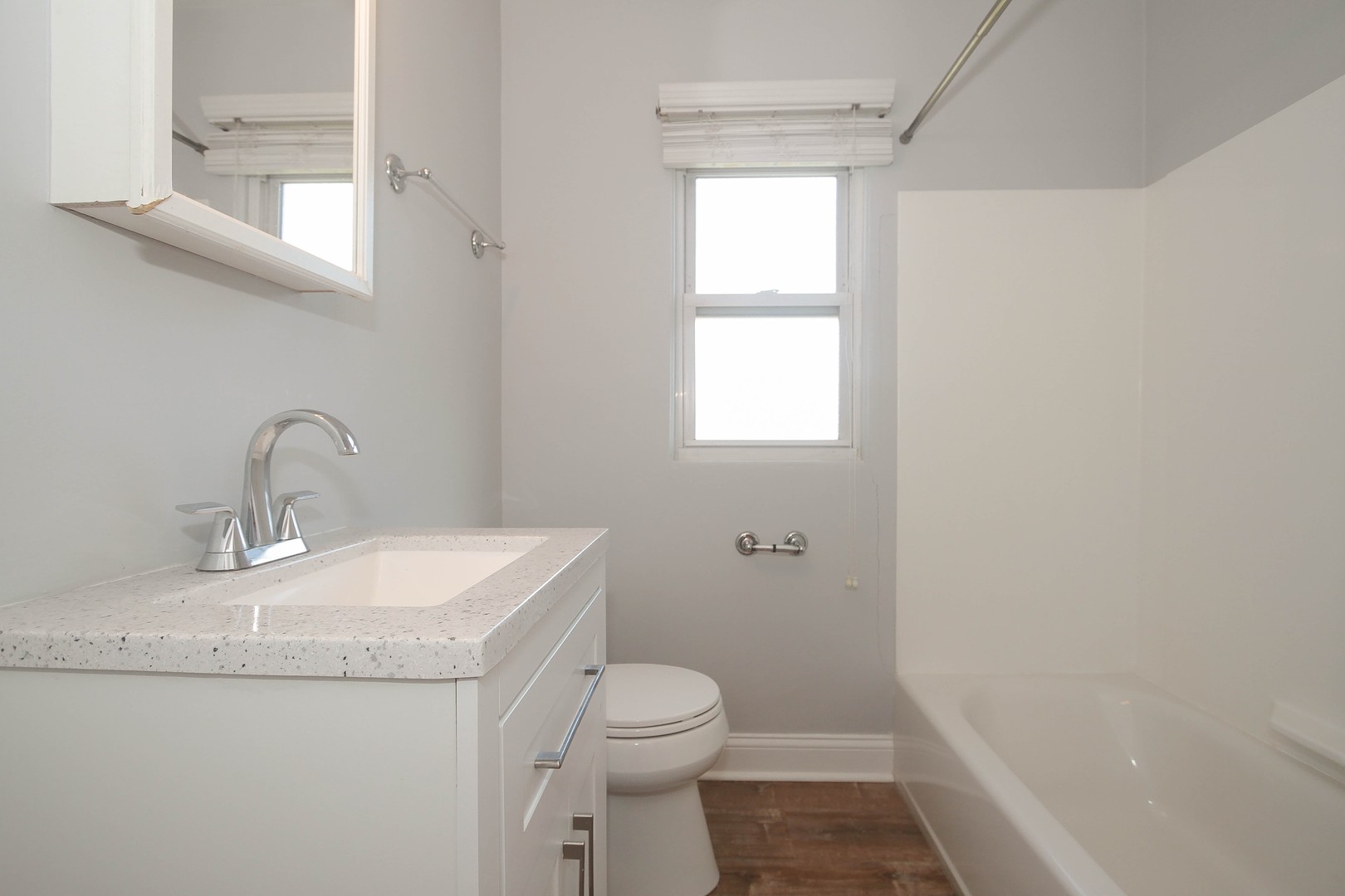 439 Elmhurst Road Mount Prospect, IL 60056 - Photo 14 of 24 a bathroom with a granite countertop sink a toilet and a bathtub