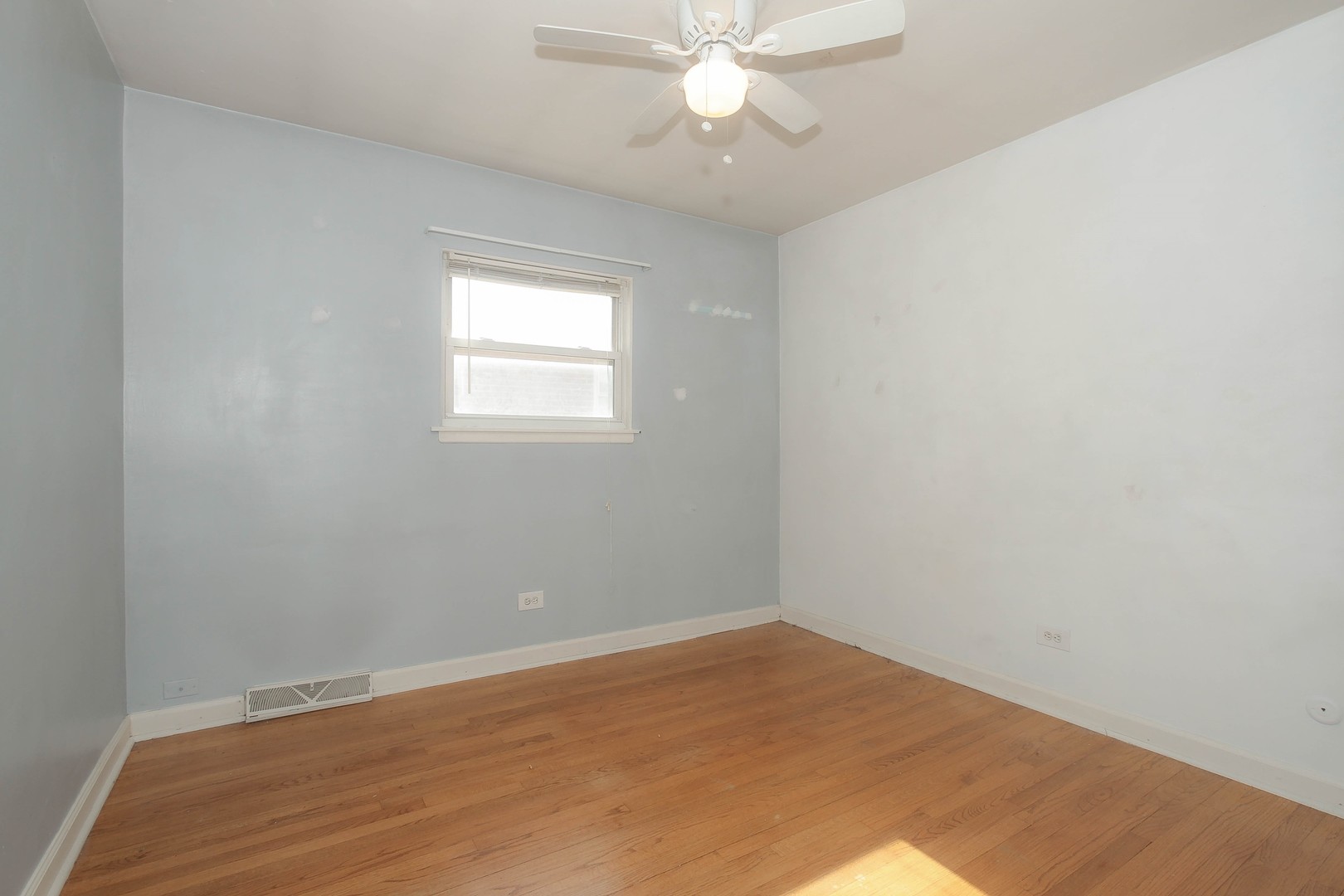 439 Elmhurst Road Mount Prospect, IL 60056 - Photo 15 of 24 an empty room with a window and chandelier fan