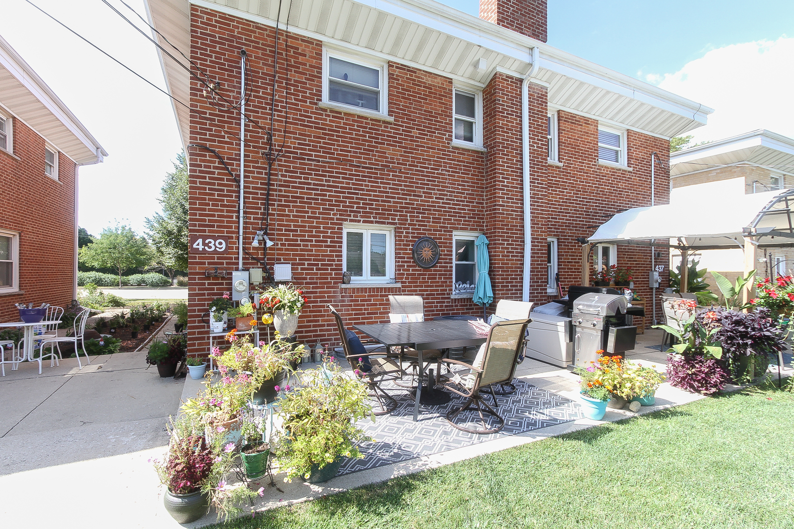 439 Elmhurst Road Mount Prospect, IL 60056 - Photo 23 of 24 a view of a house with backyard sitting area and garden
