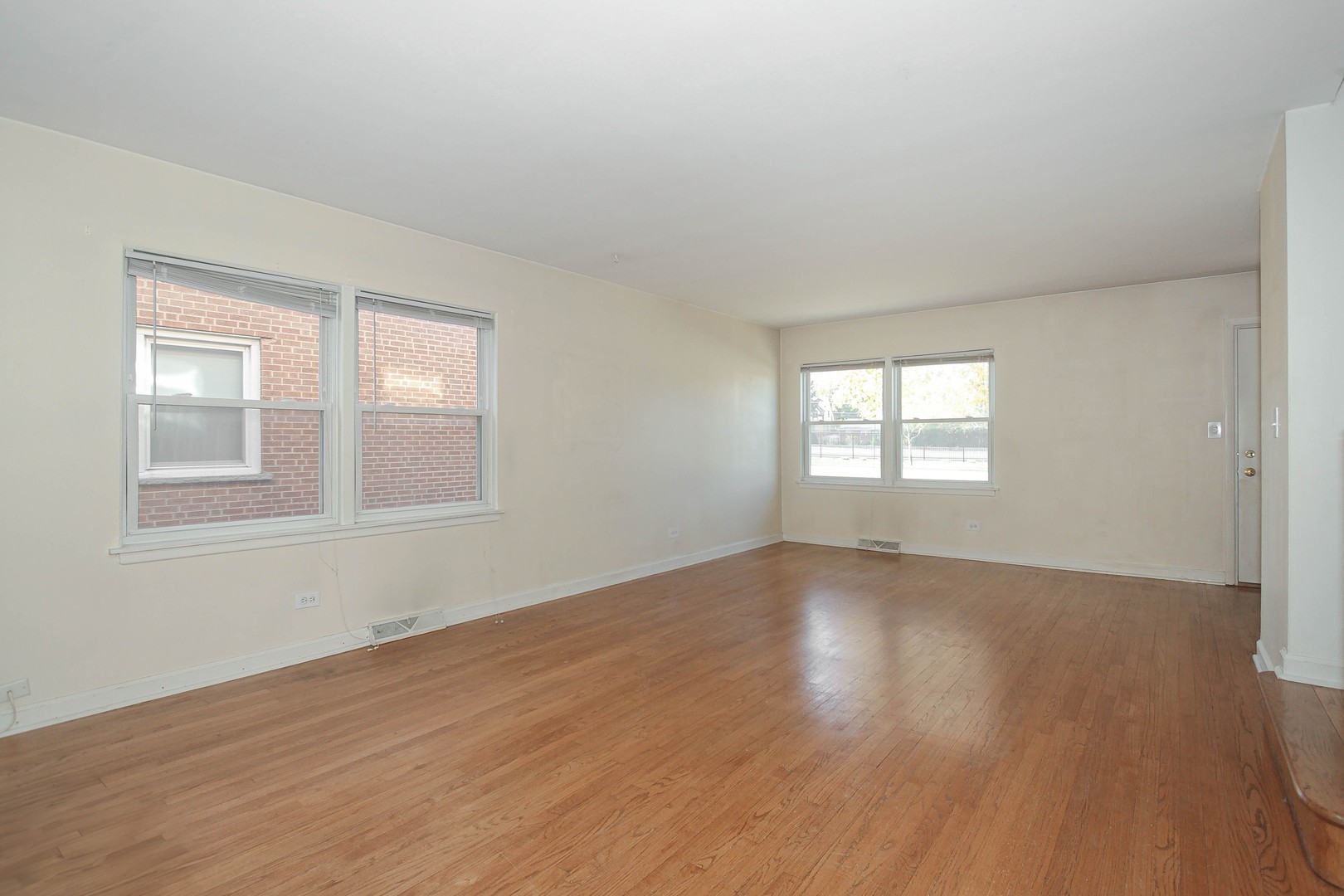 439 Elmhurst Road Mount Prospect, IL 60056 - Photo 5 of 24 a view of an empty room with wooden floor and window