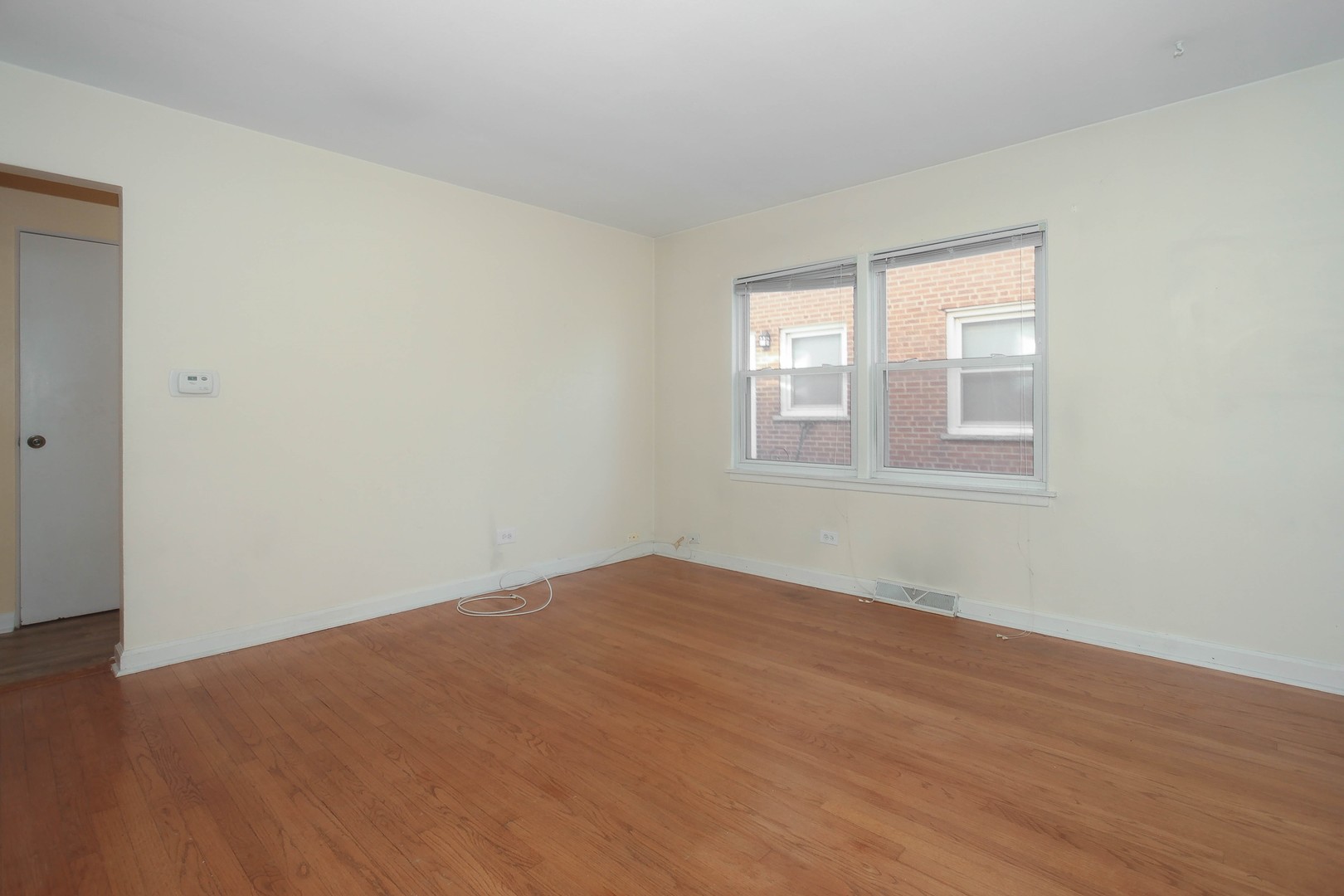439 Elmhurst Road Mount Prospect, IL 60056 - Photo 6 of 24 a view of empty room with wooden floor and fan