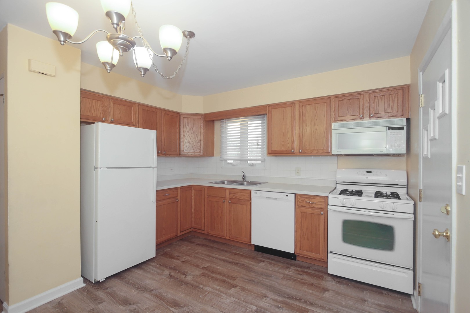 439 Elmhurst Road Mount Prospect, IL 60056 - Photo 7 of 24 a kitchen with stainless steel appliances a white stove top oven and a refrigerator