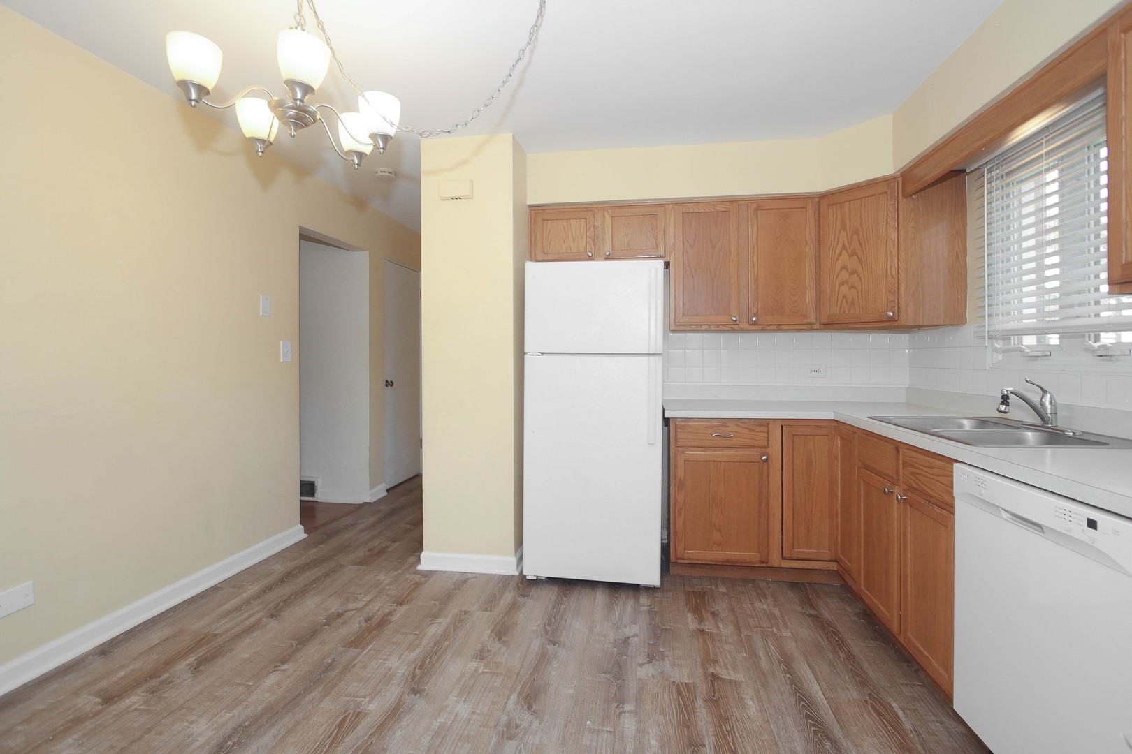 439 Elmhurst Road Mount Prospect, IL 60056 - Photo 8 of 24 a kitchen with a refrigerator a sink and cabinets