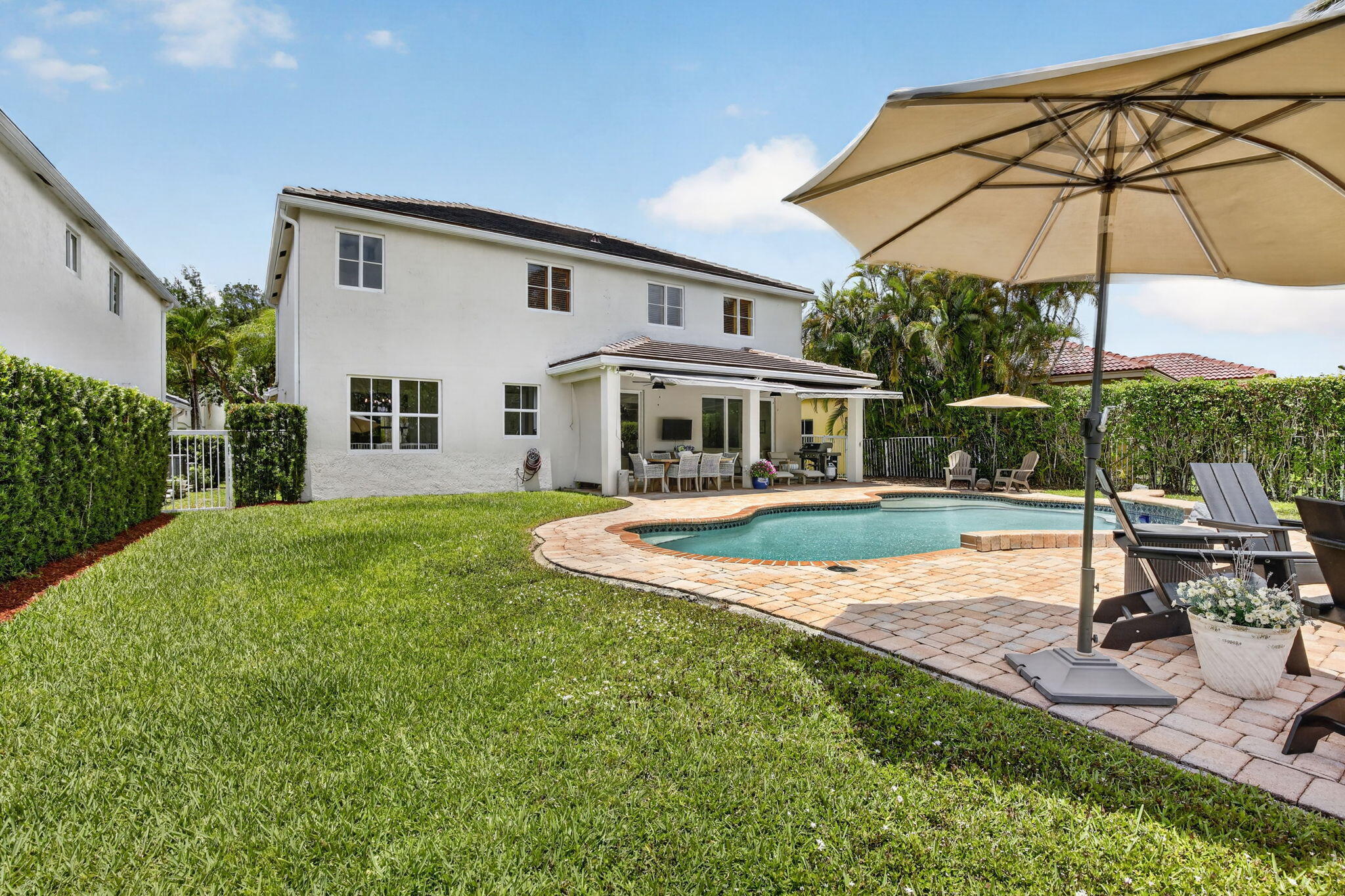 4299 Laurel Ridge Circle Weston, FL 33331 - Photo 79 of 103 a view of a house with a swimming pool and sitting area