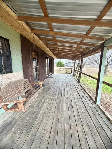 a view of outdoor space with wooden floor and stairs