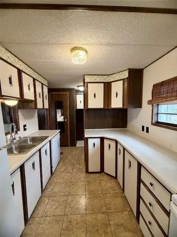 a large kitchen with a stove and cabinets