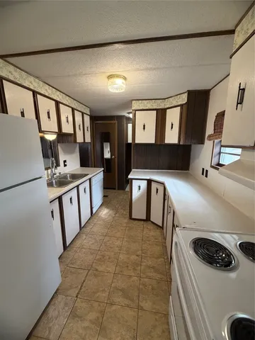 a kitchen with stainless steel appliances a stove a sink and a refrigerator
