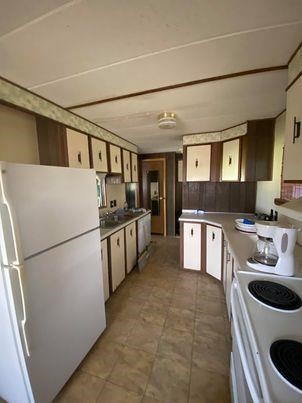 83 Roots Road Martindale, TX 78655 - Photo 5 of 9 a kitchen with a sink a stove and refrigerator