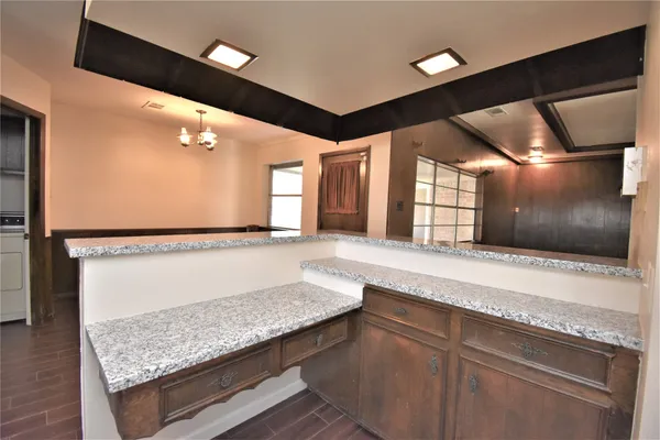 a living room with granite countertop furniture and a flat screen tv