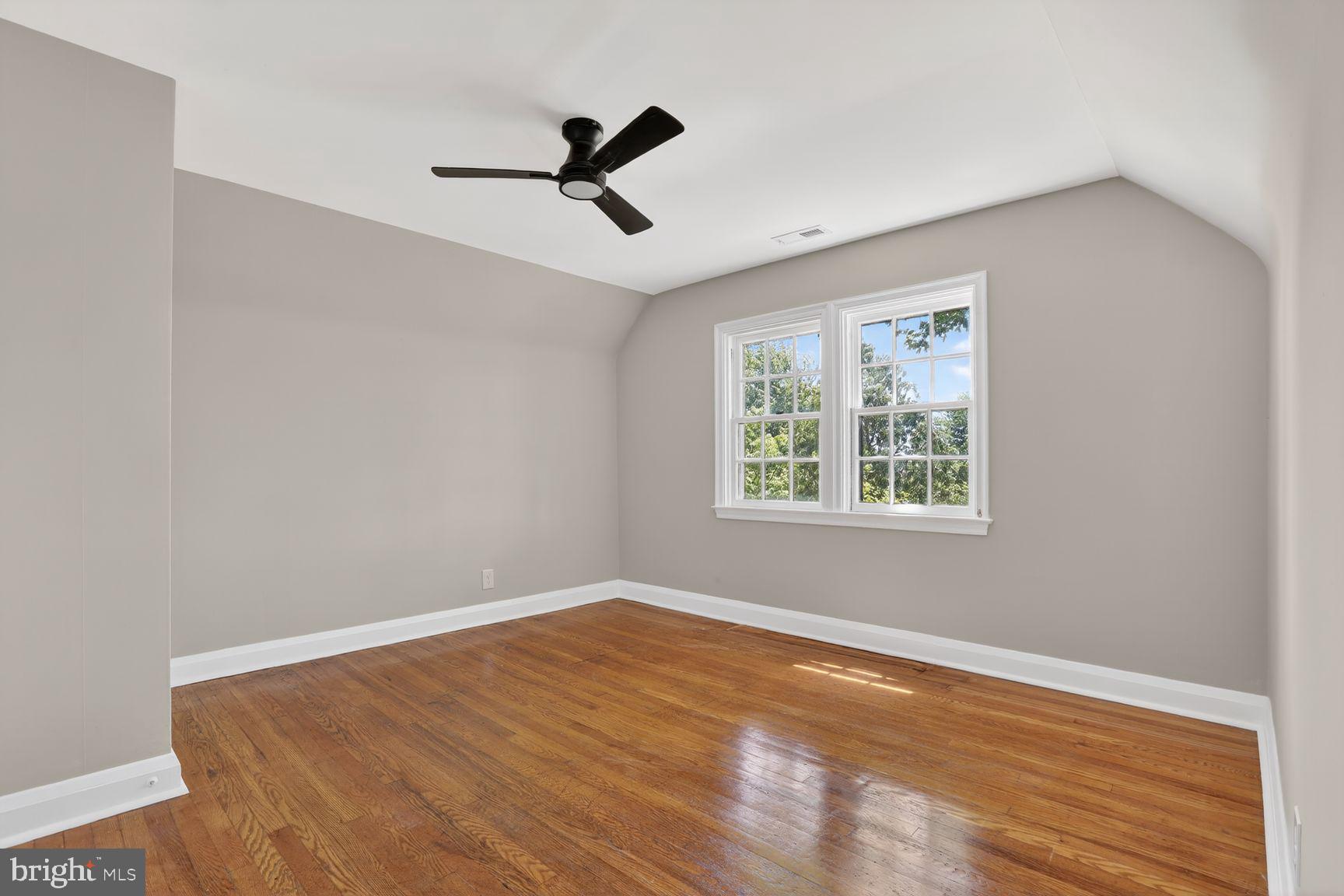 315 East Cold Spring Lane Baltimore, MD 21212 - Photo 14 of 25 a view of empty room with wooden floor and fan