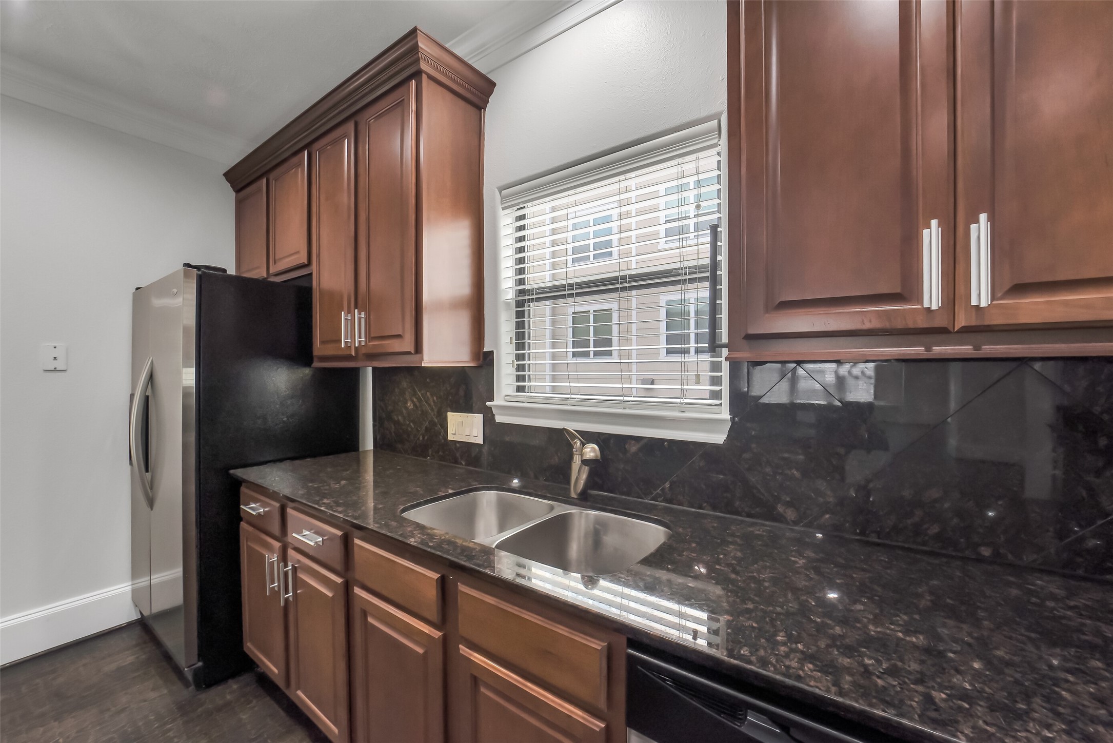 1335 Studer Street Houston, TX 77007 - Photo 12 of 37 a kitchen with stainless steel appliances granite countertop a sink stove and refrigerator