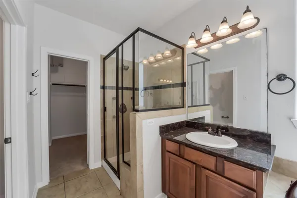 a bathroom with a sink vanity granite and a mirror