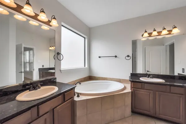 a bathroom with a double vanity sink and a mirror