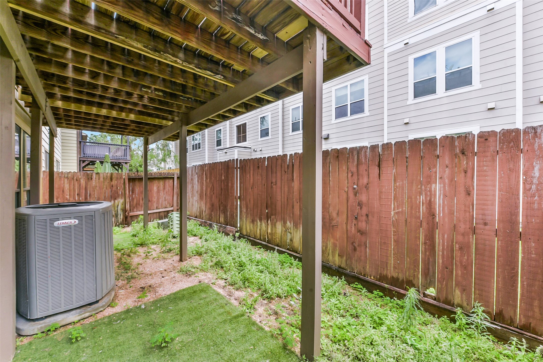 1335 Studer Street Houston, TX 77007 - Photo 31 of 37 a backyard of a house with lots of green space wooden fence and plants