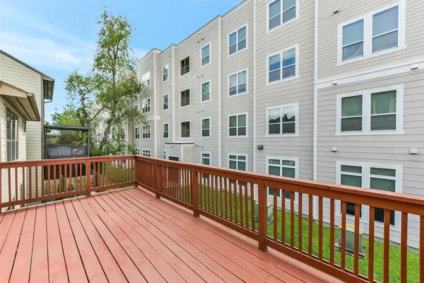a view of balcony with wooden floor and fence