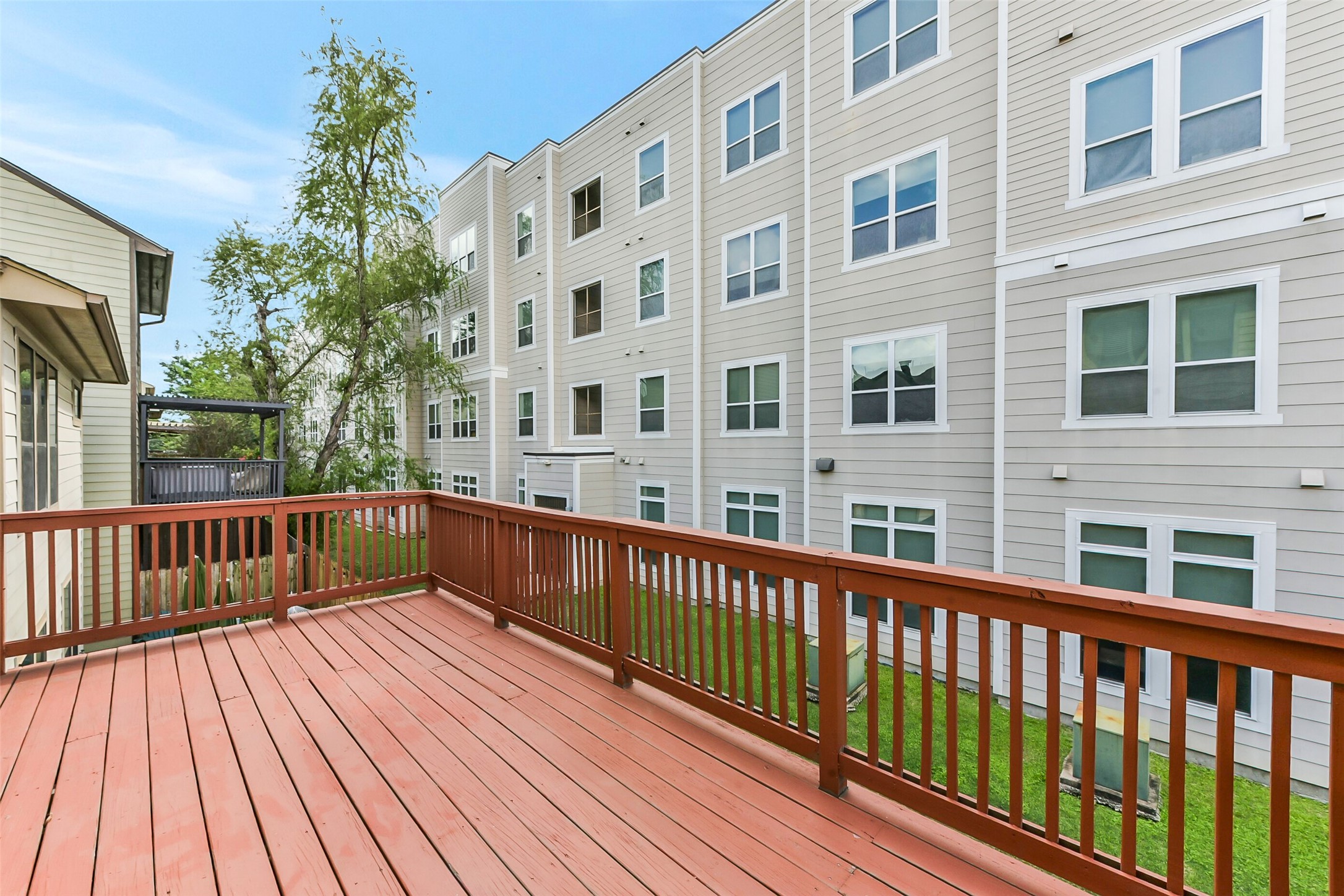 1335 Studer Street Houston, TX 77007 - Photo 36 of 37 a view of balcony with wooden floor and fence