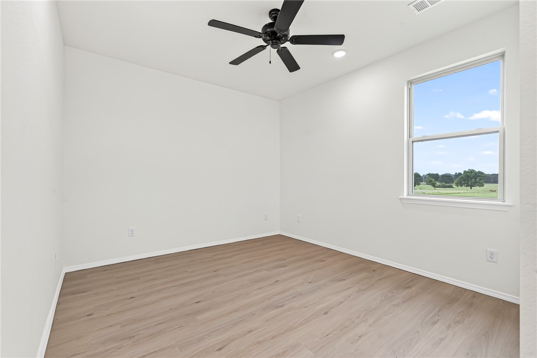 6138 New Hope Road Hackett, AR 72937 - Photo 24 of 56 Spacious room with wood-finish flooring, a ceiling fan, and a single window offering expansive outdoor scenery