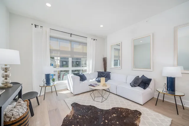 a living room with furniture lamp and window