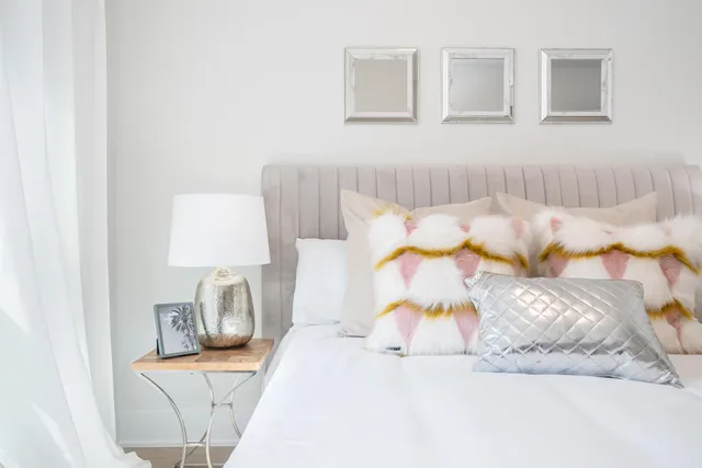 a bedroom with a bed and a lamp