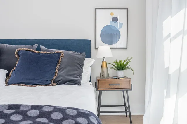 a bed sitting in a bedroom next to a window