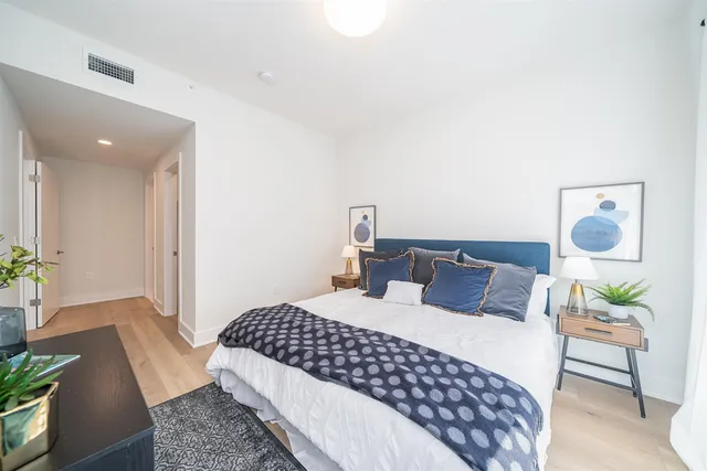 a bedroom with a bed and wooden floor