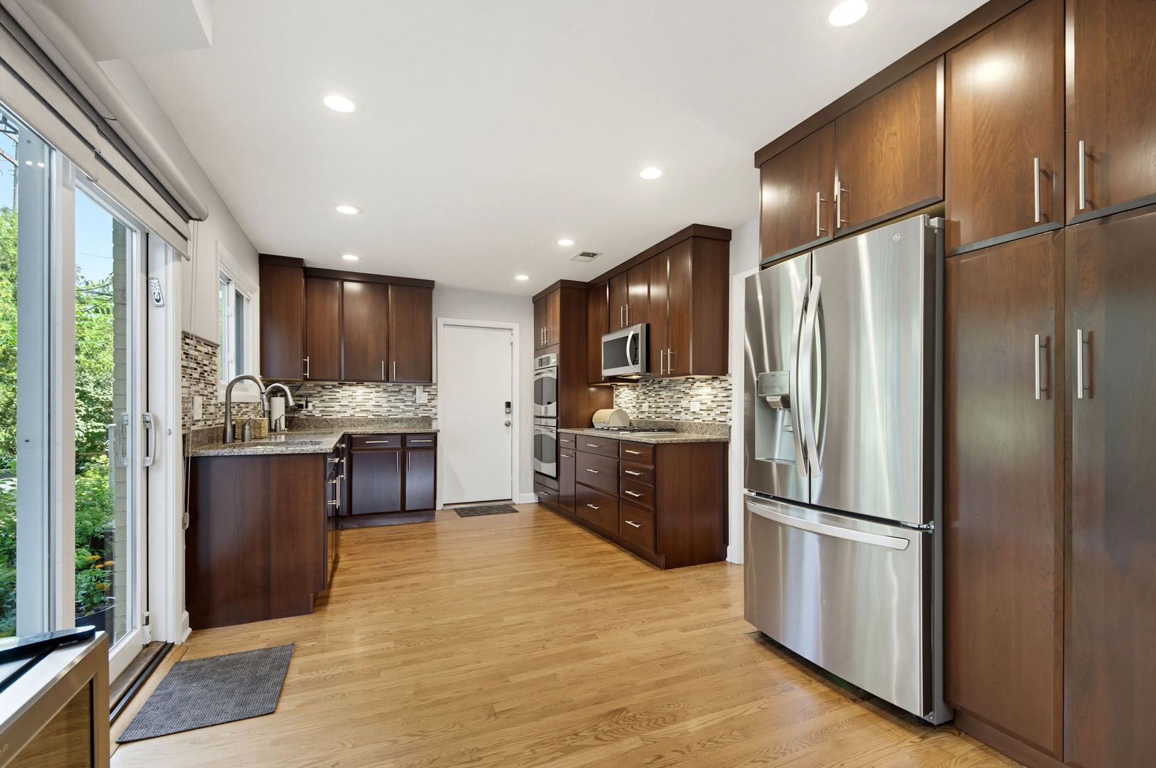 9200 Ridgeway Avenue Evanston, IL 60203 - Photo 9 of 33 a kitchen with stainless steel appliances granite countertop a refrigerator stove and oven