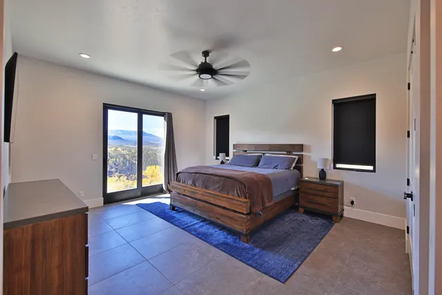 a bedroom with a large bed and a chandelier