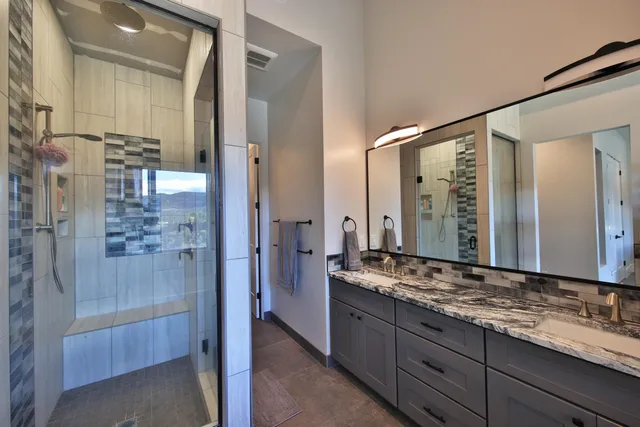 a bathroom with a granite countertop sink mirror and double