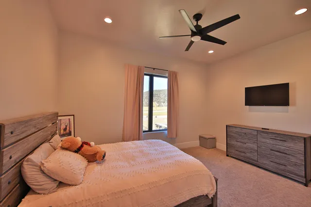 a bedroom with a bed and a flat screen tv