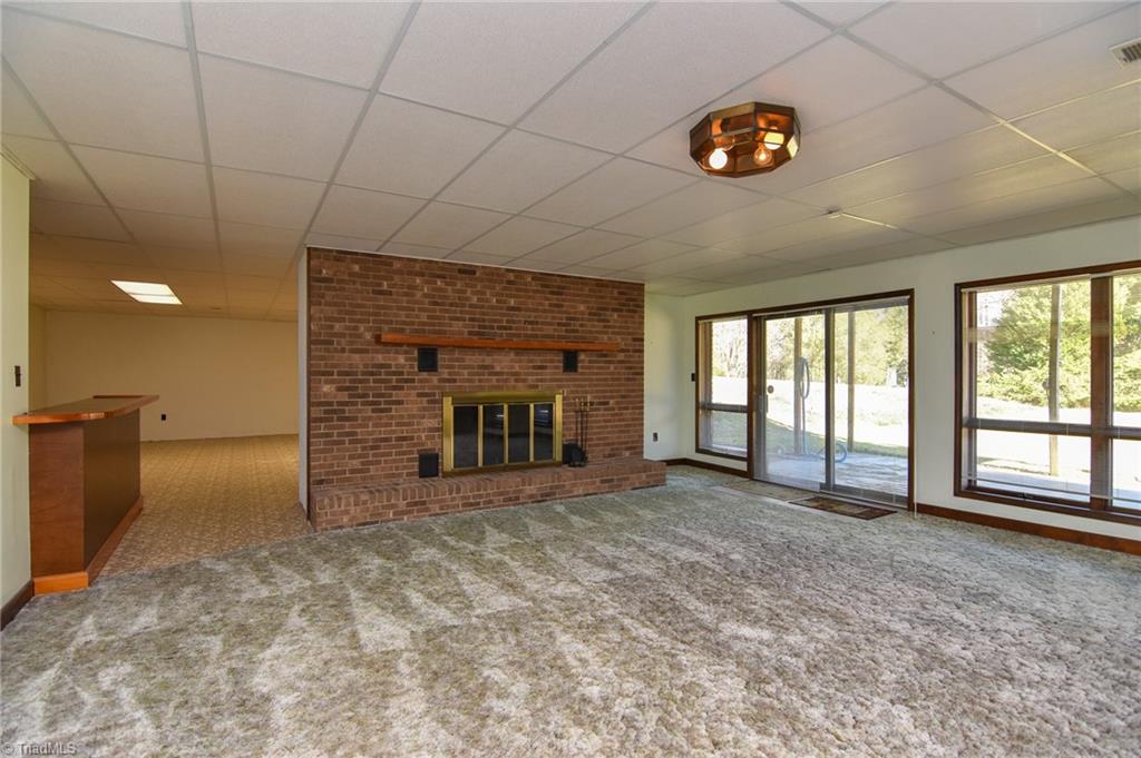 5959 Holder Road Clemmons, NC 27012 - Photo 33 of 40 Lower Level Den with Fireplace and access to Patio and Pool