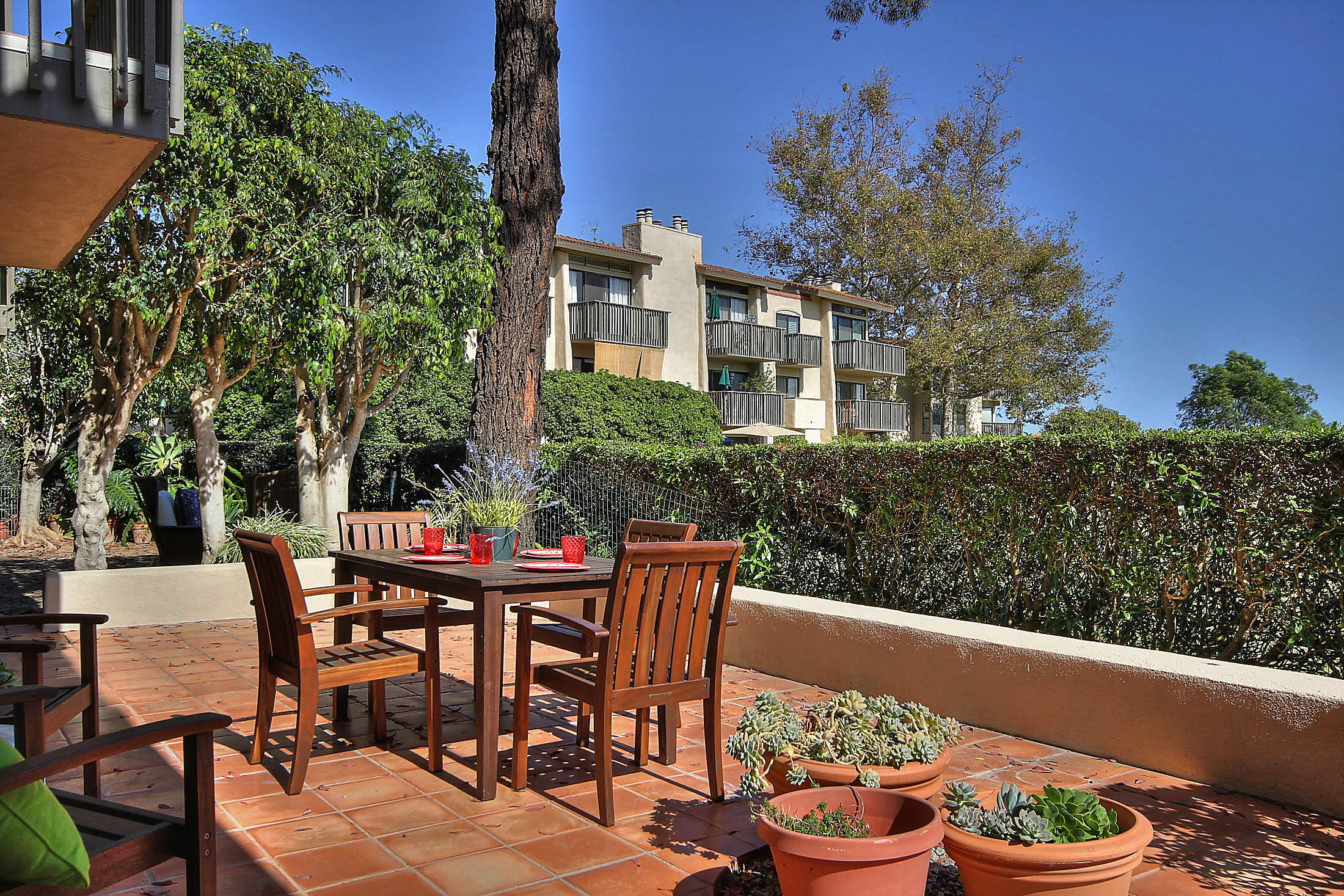 3375 Foothill Road, Unit 1114 AND 1113 Carpinteria, CA 93013 - Photo 26 of 27 a view of a patio with table and chairs and potted plants
